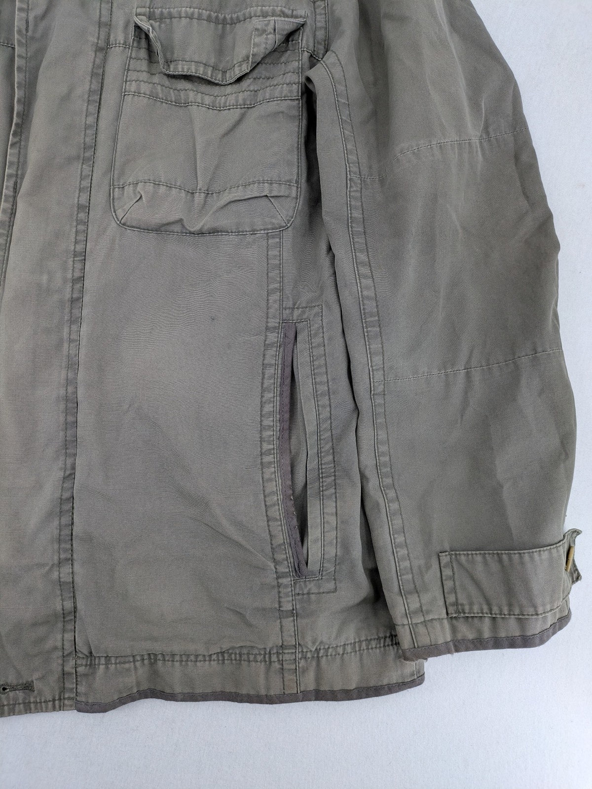Walbusch khaki military jacket with checkered blue-white lining and multiple pockets.