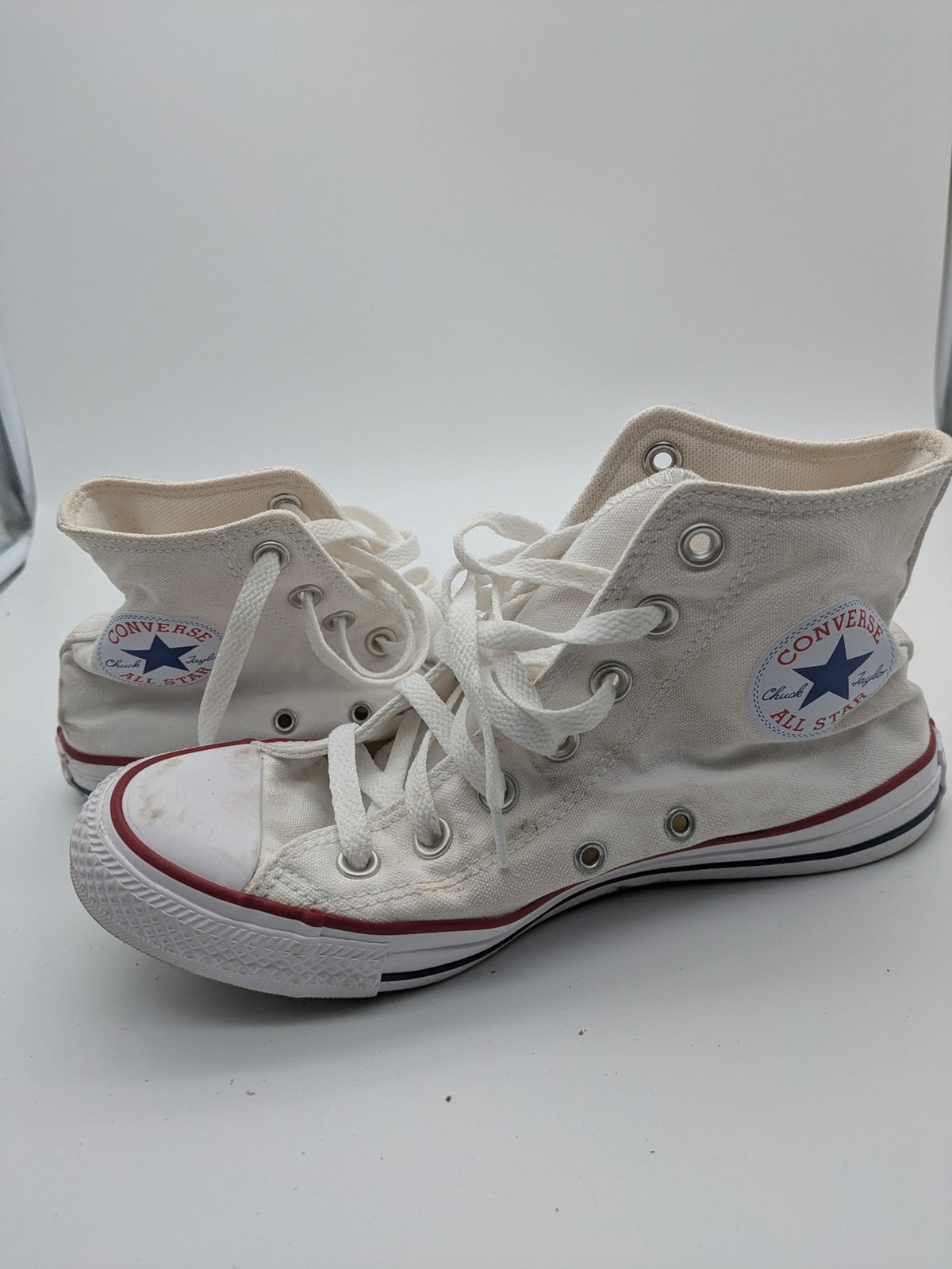 Converse Chuck Taylor All Star high top sneakers black canvas with red and white accents.