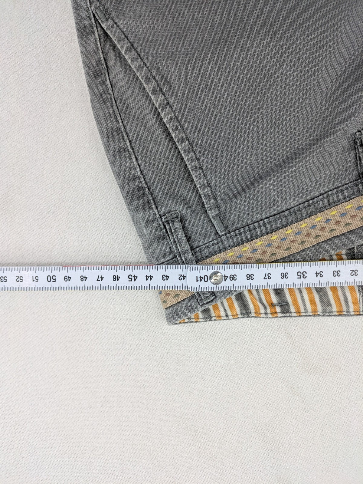 MMX grey chino pants with patterned interior lining and contrasting waistband, made from organic cotton.