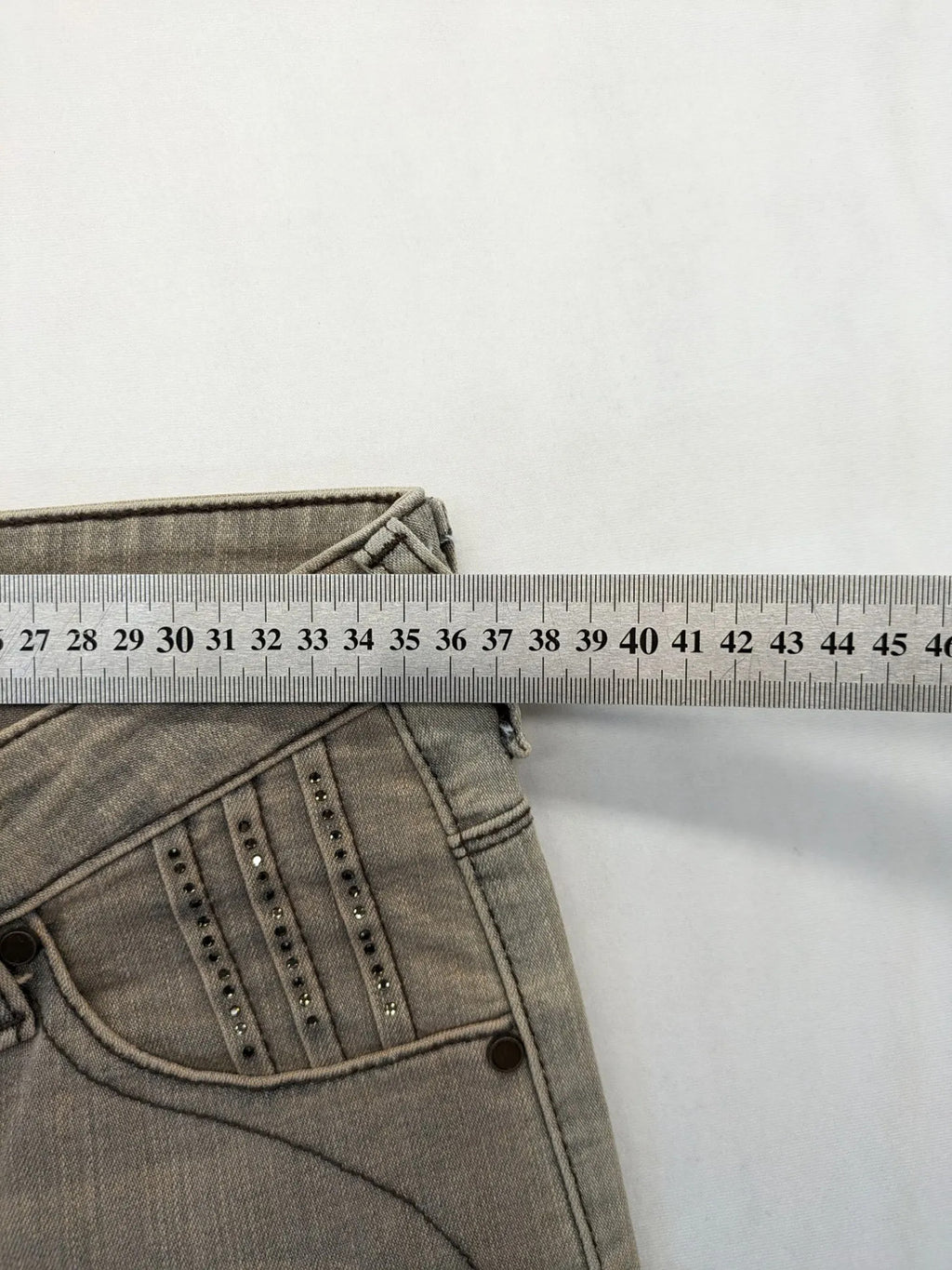 Masha khaki straight jeans with rhinestone embellishments and decorative stitching.