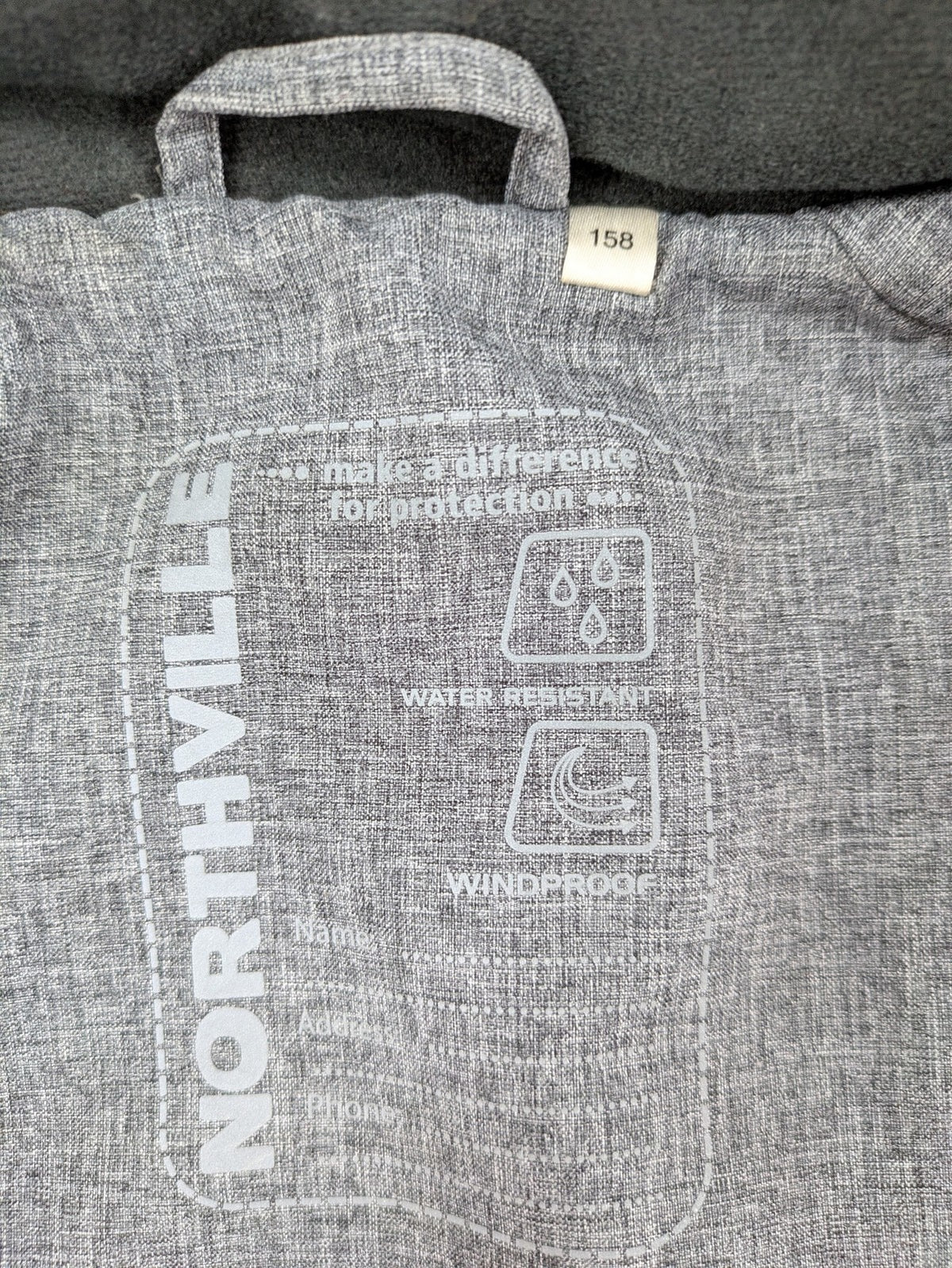 Northville grey and red softshell jacket with hood, fleece lining, and reflective elements.