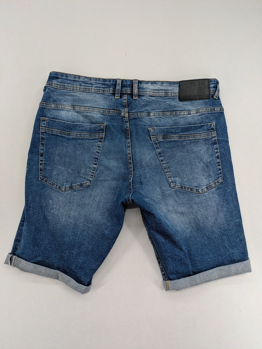 Smog blue denim shorts slim fit distressed details with rolled hem.