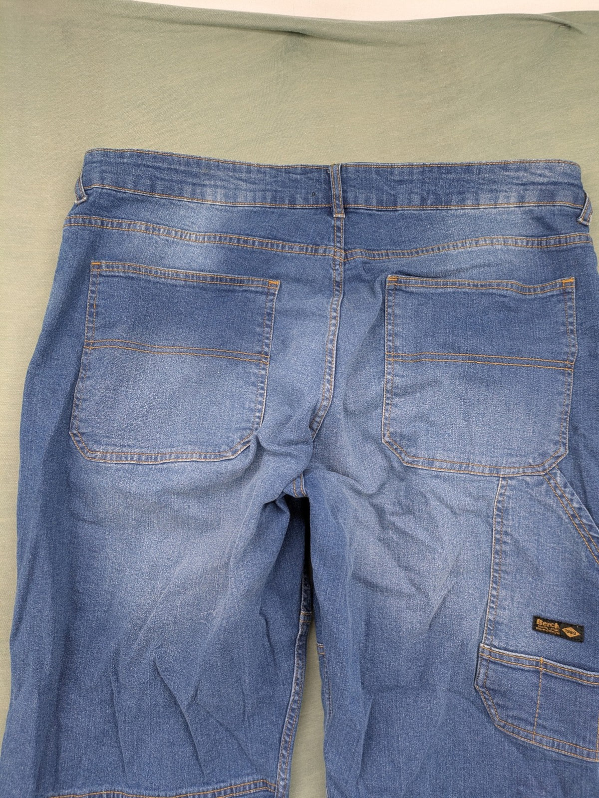 Bench blue straight jeans with reinforced knees and multiple cargo pockets.