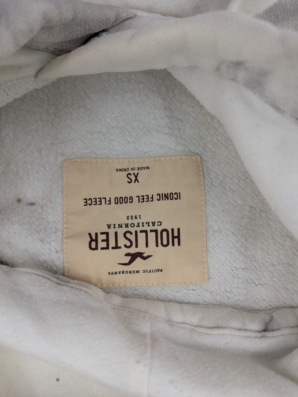 Hollister grey and white tie-dye hoodie with logo on chest, back, and sleeve.