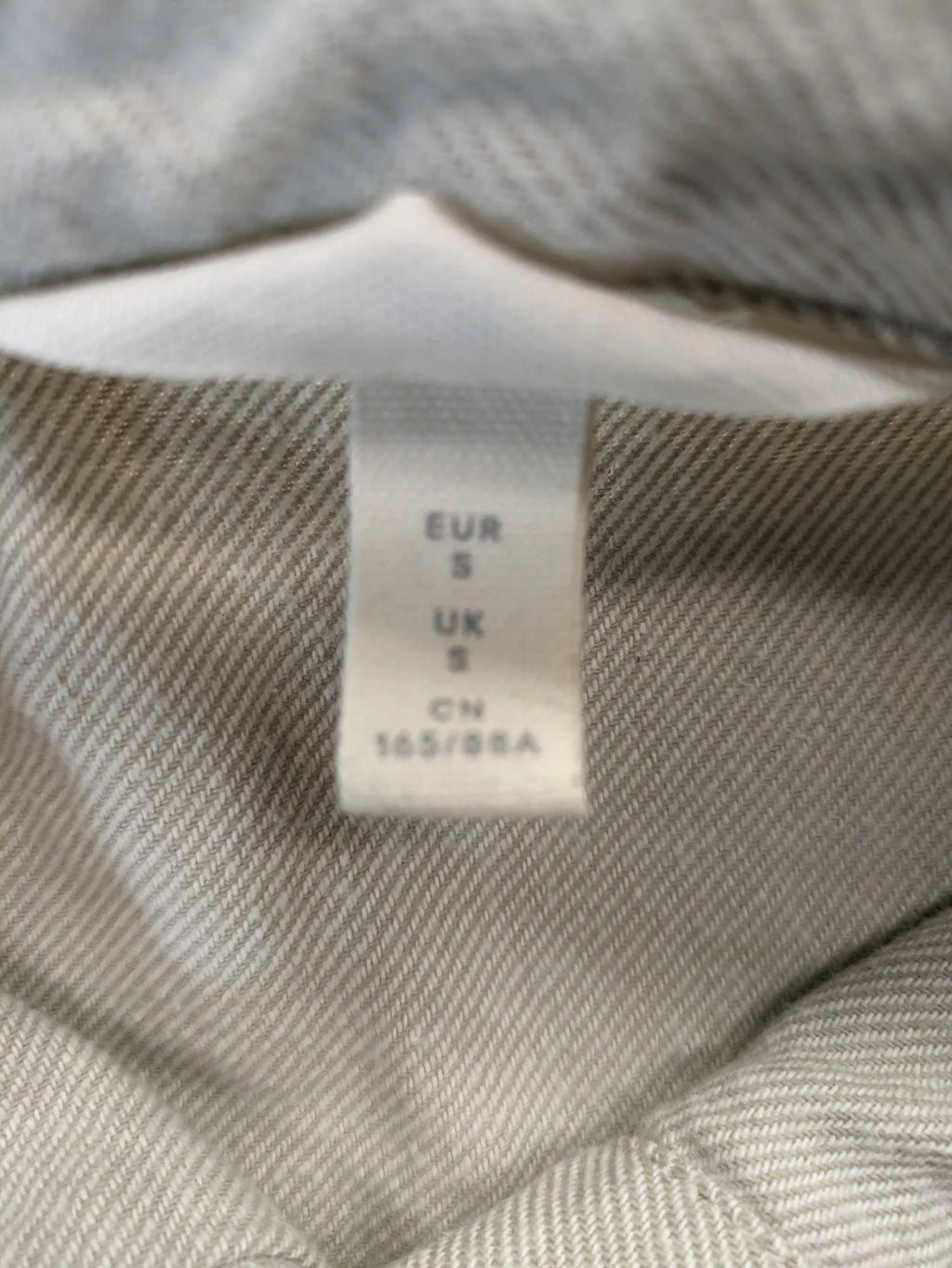 H&M beige overshirt jacket, classic collar, button-down front, two chest pockets, cotton material.