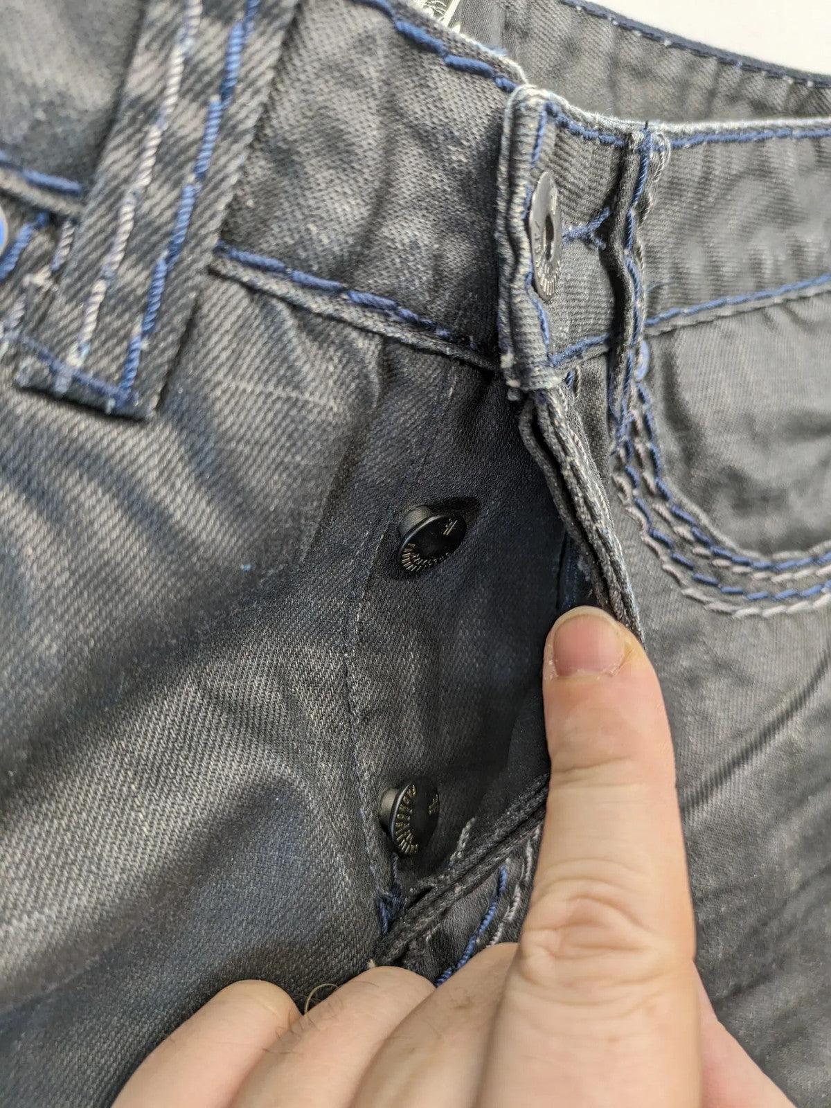 Fadnoble grey straight jeans with button fly and contrasting stitching details.