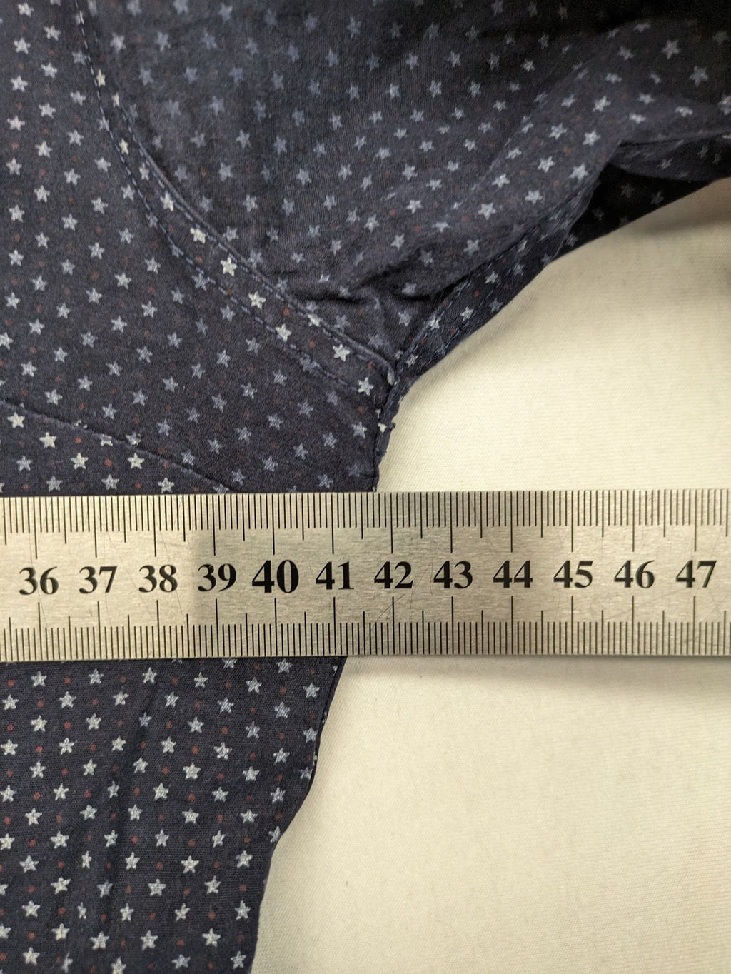 Tommy Hilfiger navy button-down shirt with white star pattern and embroidered flag logo.