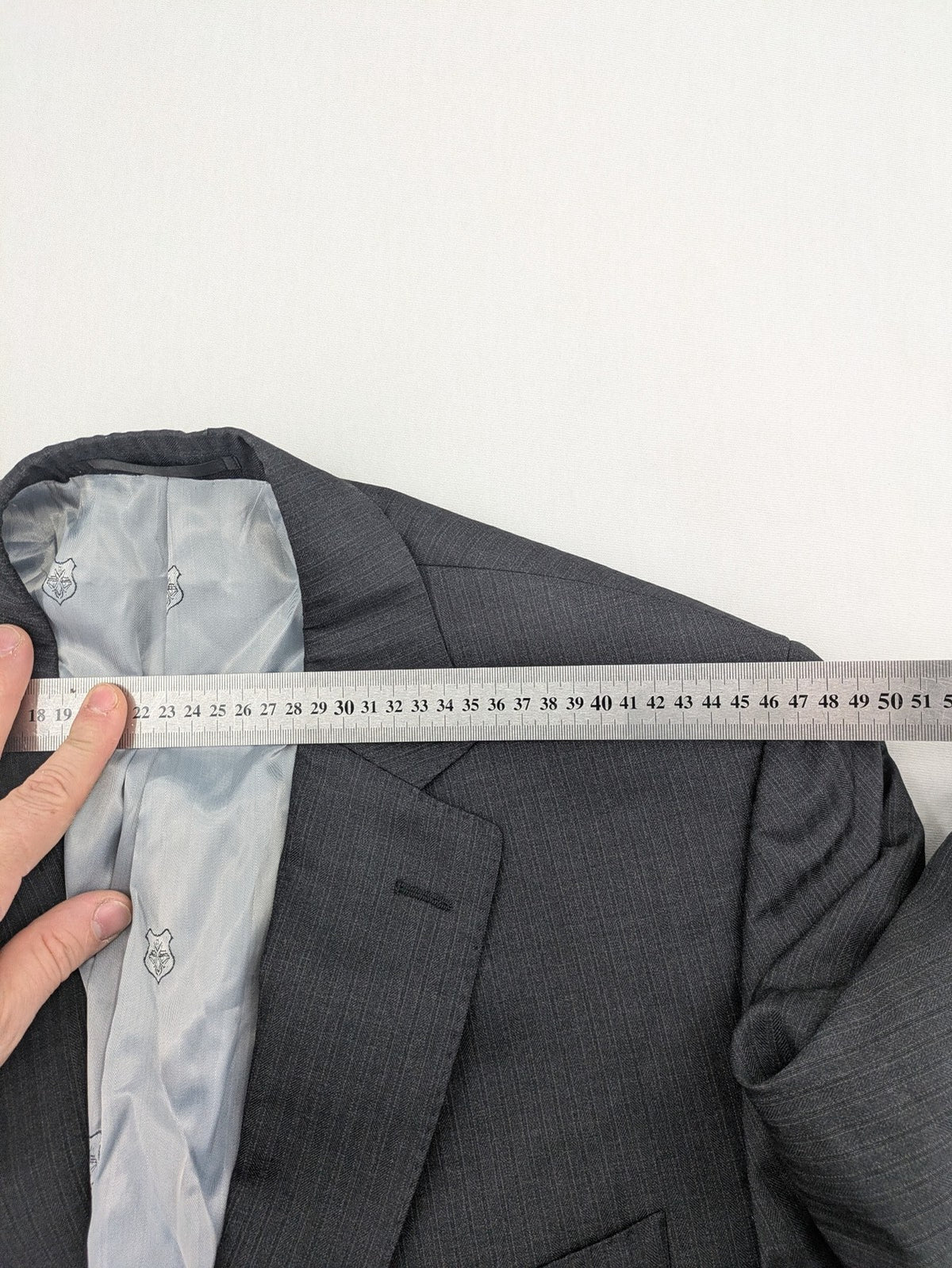 Desch grey blazer with dark grey pinstripe pattern, satin lining, and tailored design.
