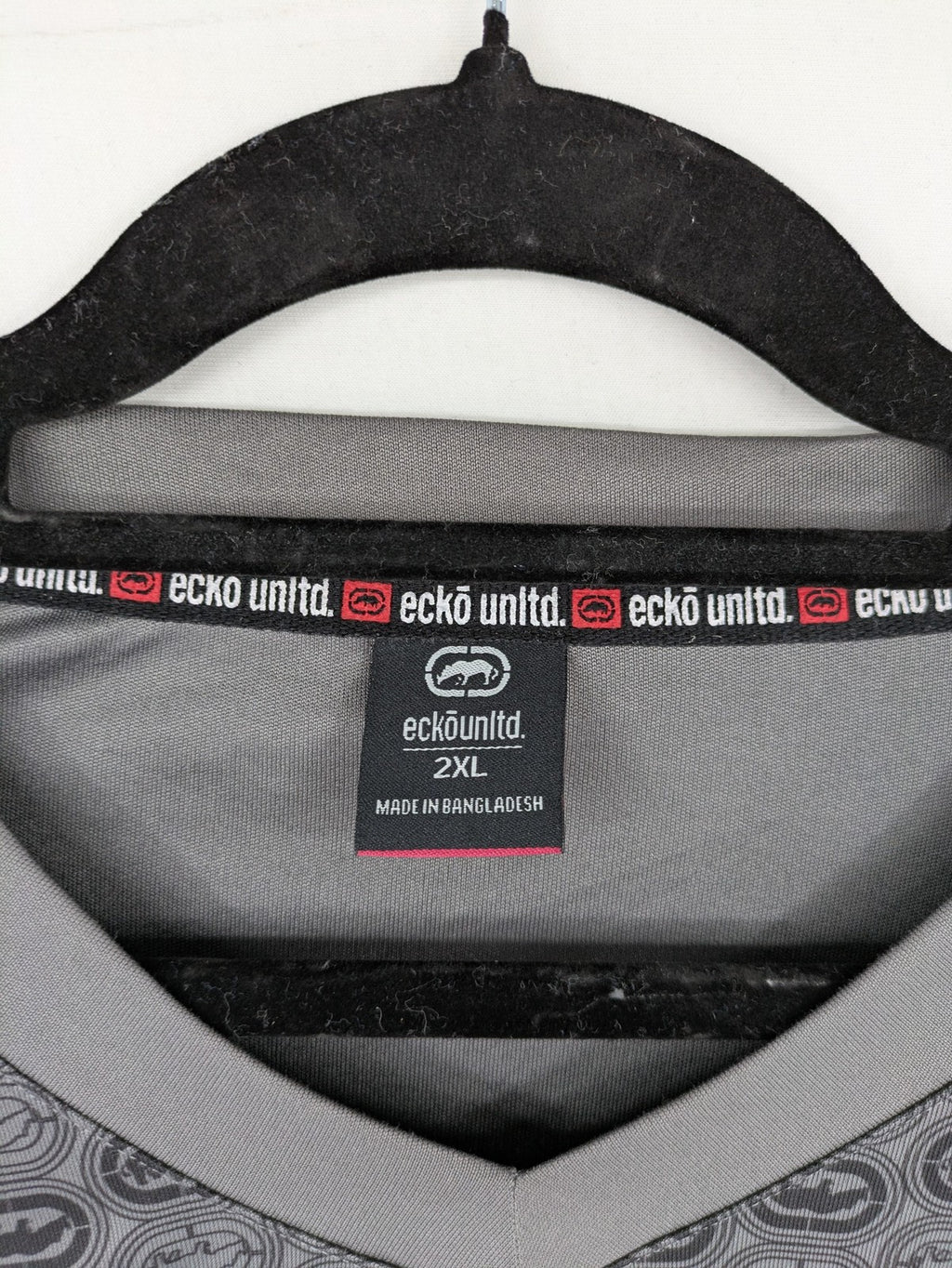Ecko Unltd. grey soccer uniform V-neck with all-over logo print and embroidered FC patch.