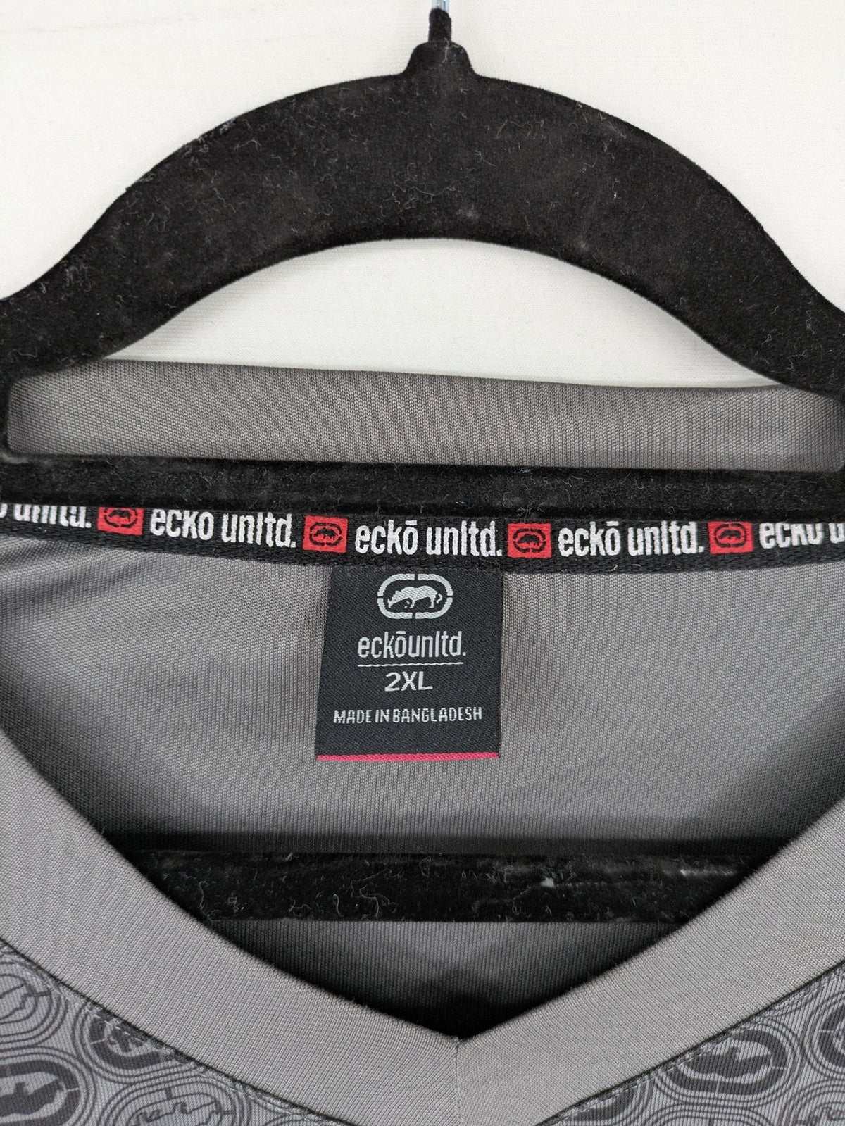 Ecko Unltd. grey soccer uniform V-neck with all-over logo print and embroidered FC patch.