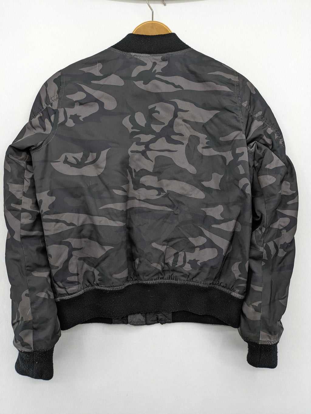 FB Sister orange bomber jacket with gray camouflage pattern and quilted lining.