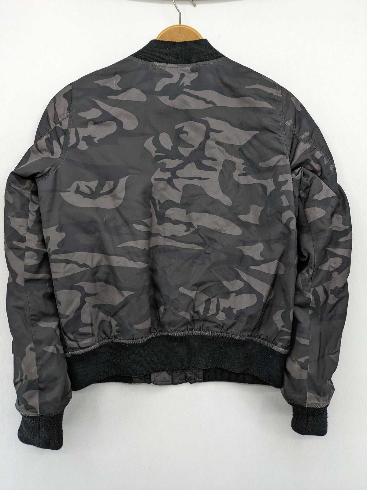 FB Sister orange bomber jacket with gray camouflage pattern and quilted lining.