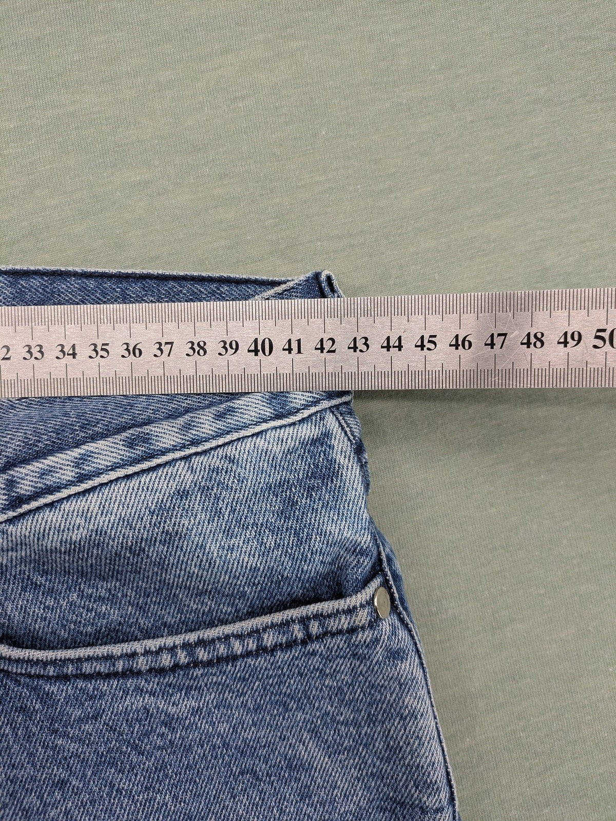 Wrangler blue straight jeans with button fly and classic 5-pocket design.