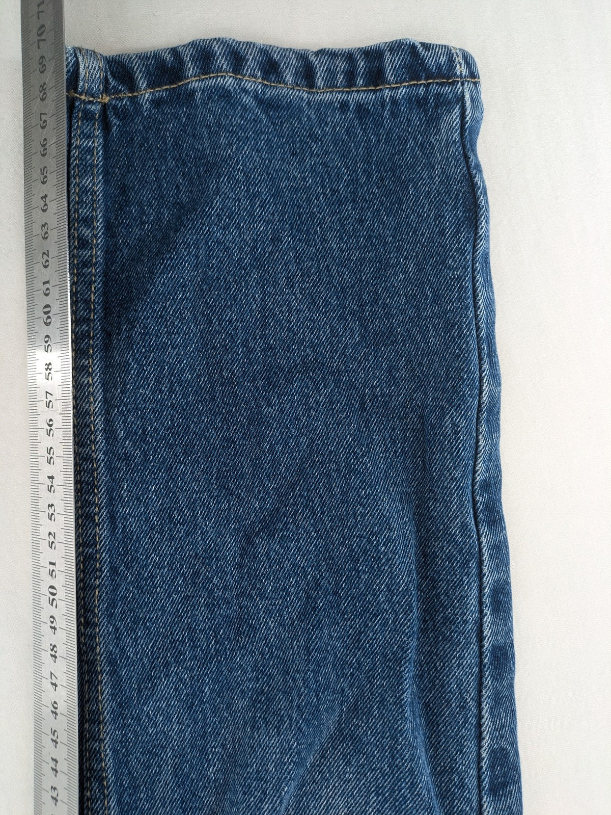 FSBN blue straight jeans with distressed knee rips and classic button fly.