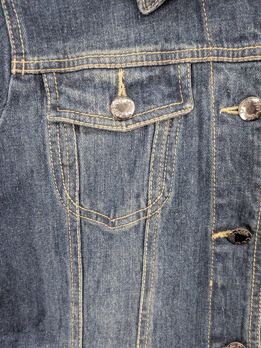 BLU blue denim trucker jacket with button placket and two chest pockets.
