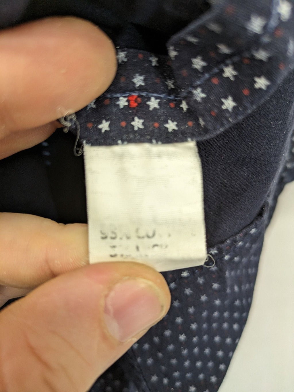 Tommy Hilfiger navy button-down shirt with white star pattern and embroidered flag logo.