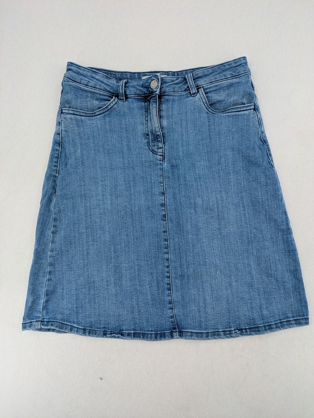 Tchibo blue A-line denim skirt classic five-pocket design with zipper and button closure.