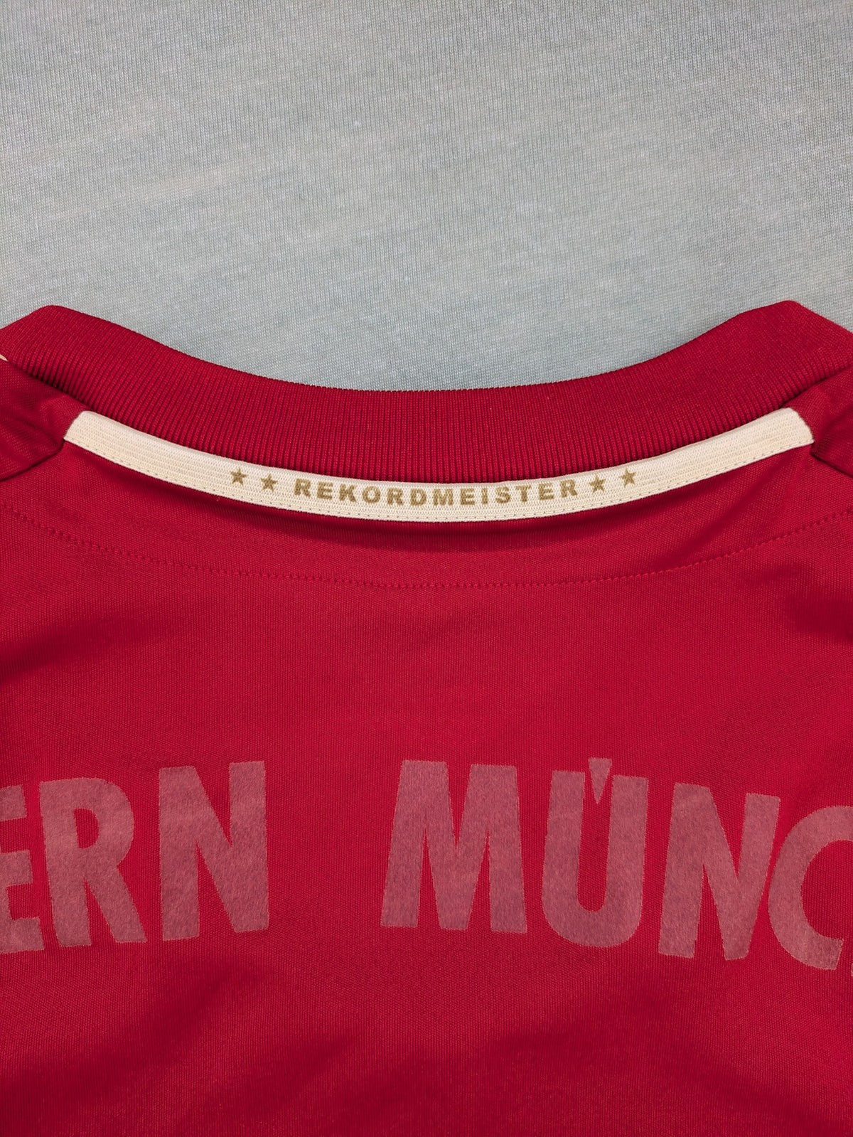 Adidas red soccer uniform with embroidered FC Bayern München crest and T-Mobile logo.
