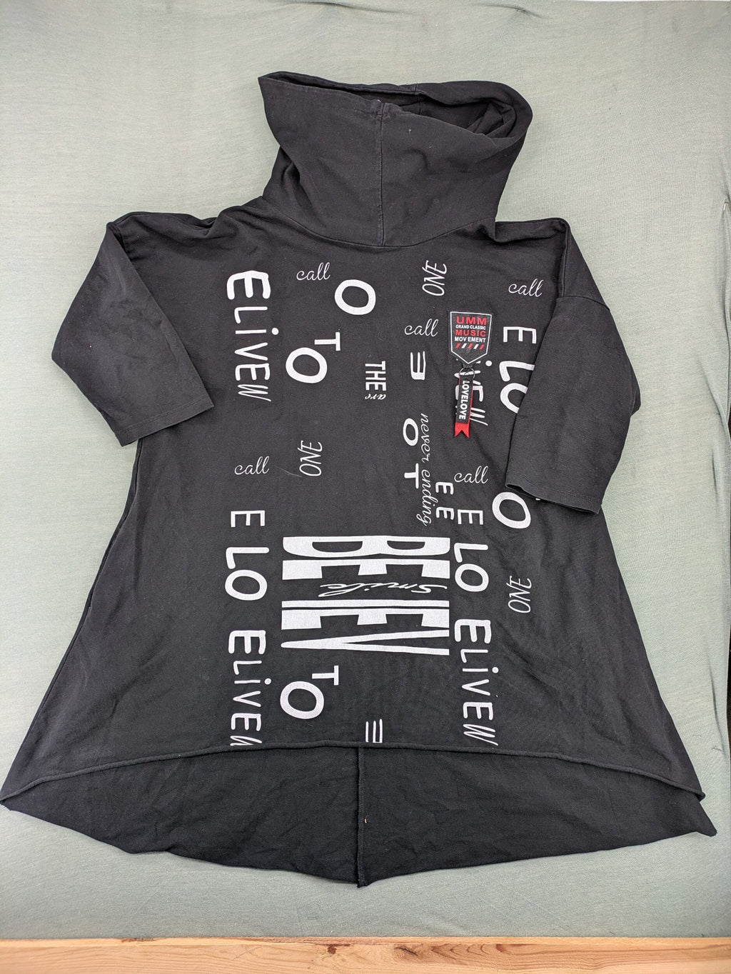 MEGI Collection black hoodie dress with graphic print and asymmetrical high-low hem.