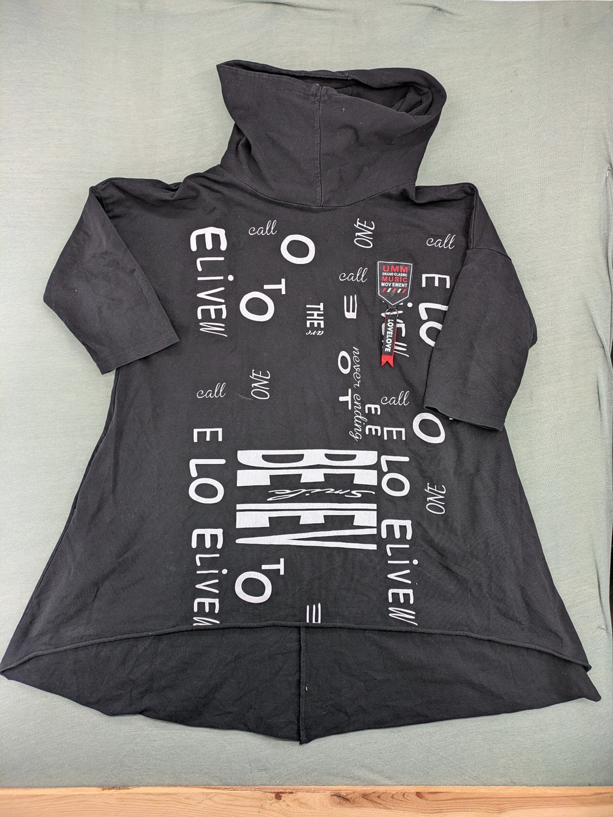 MEGI Collection black hoodie dress with graphic print and asymmetrical high-low hem.