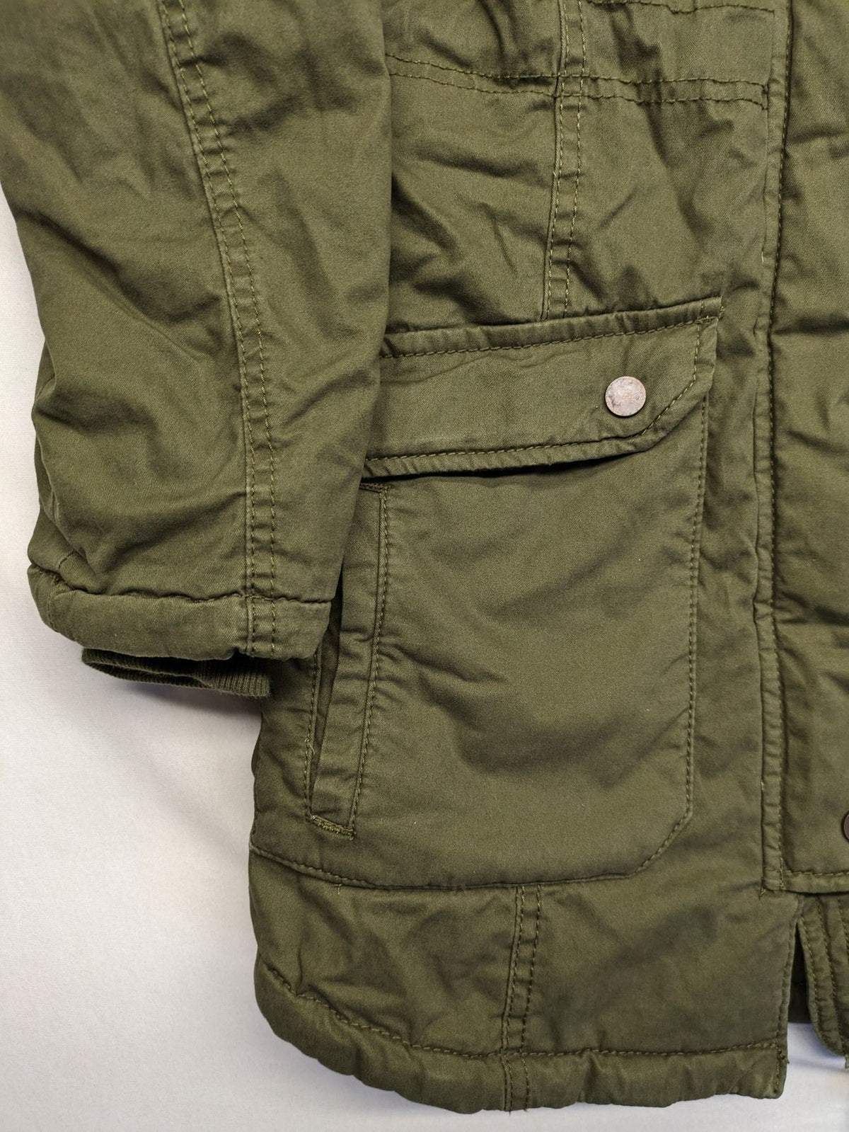 Vp Fashion khaki parka coat with "Bloomin' Lovely" floral embroidery and quilted lining.