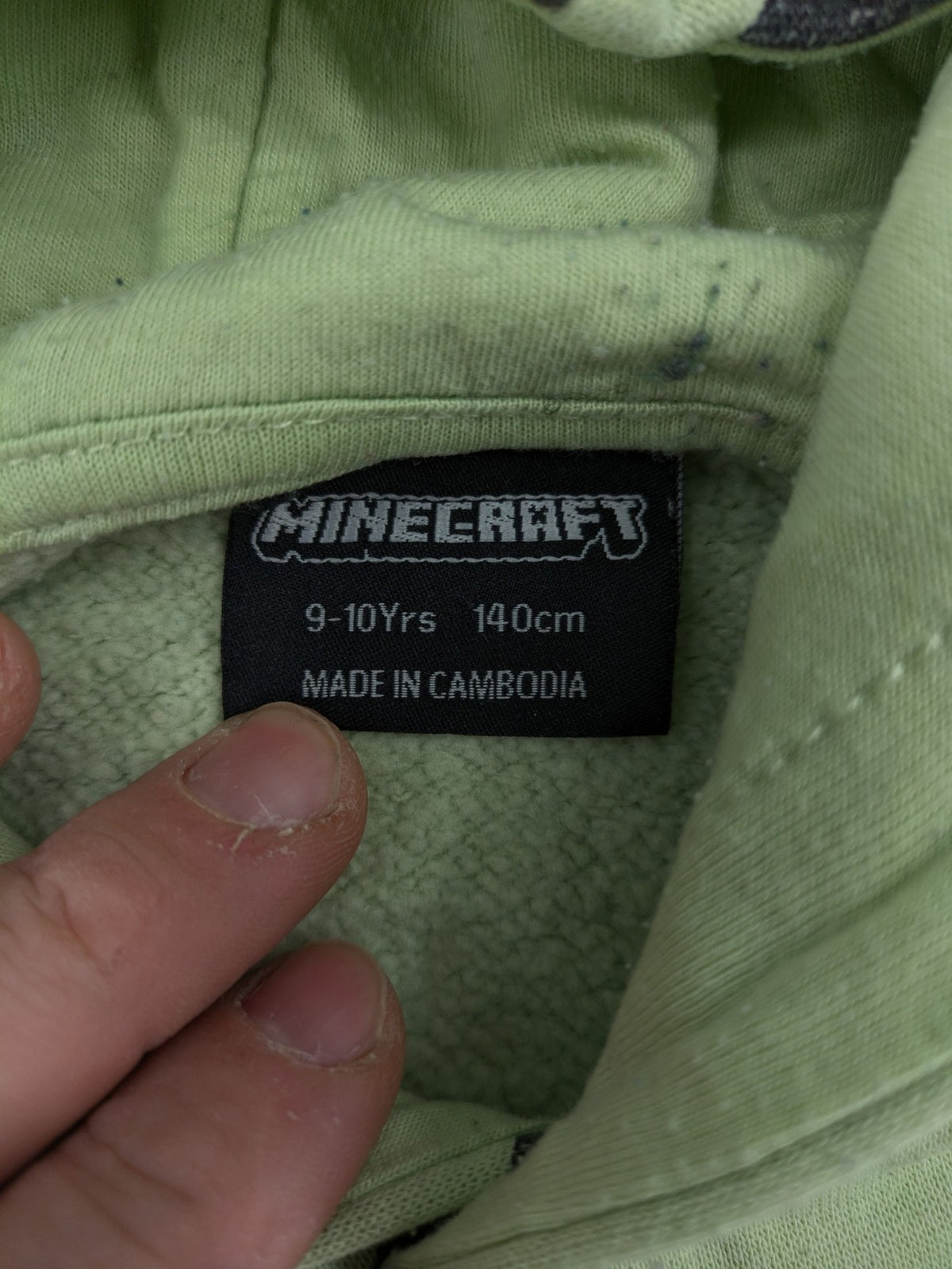Minecraft zip-through hoodie green all-over print with Creeper and logo details.