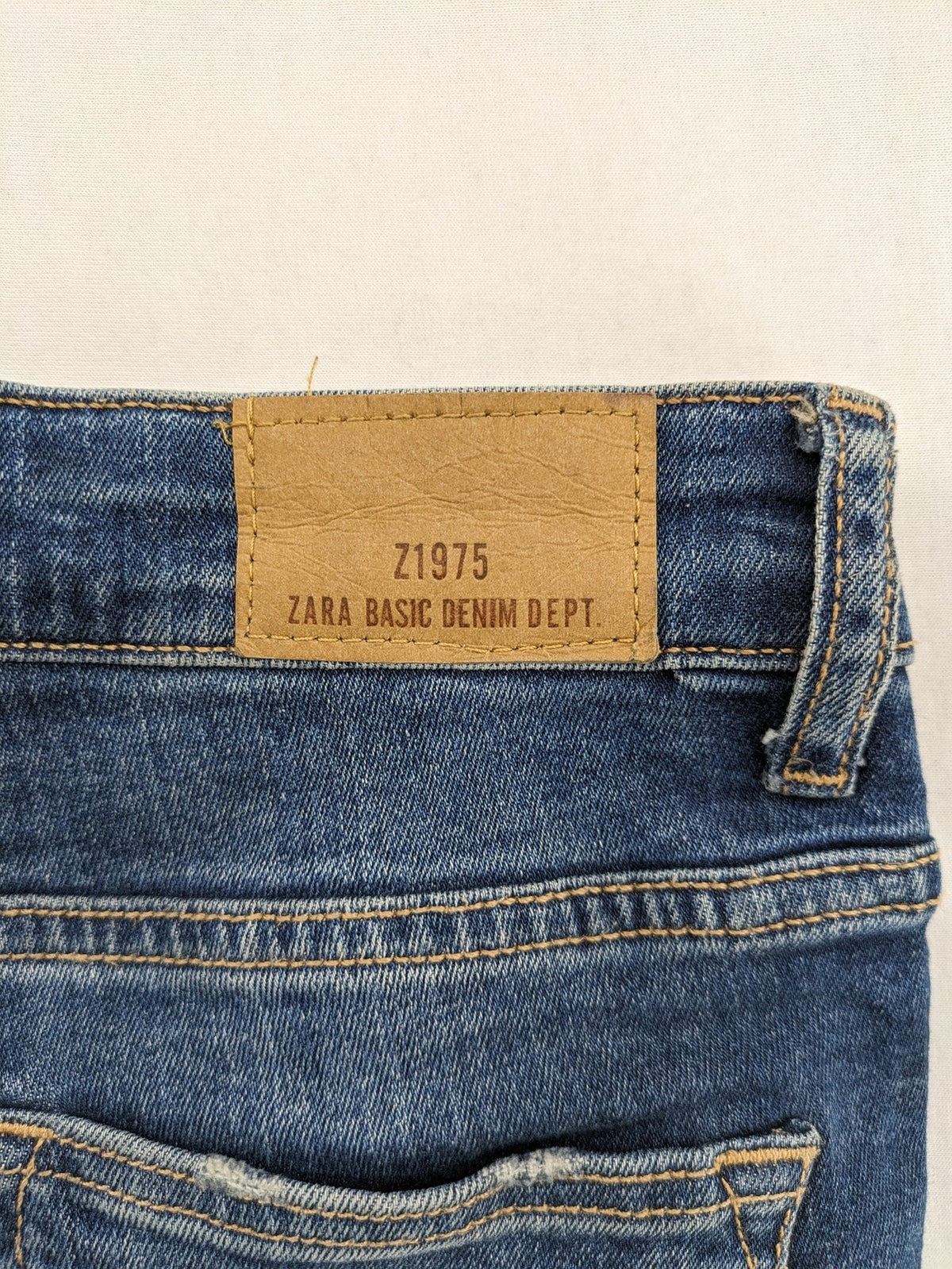 Zara Basic blue skinny jeans with destroyed knee details and frayed hem.