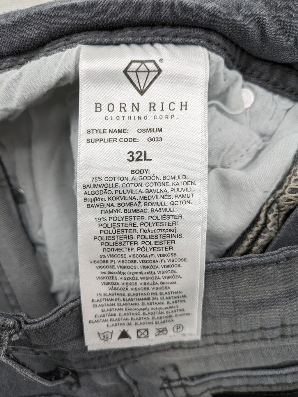 Born Rich grey slim fit jeans with button fly and washed denim texture.