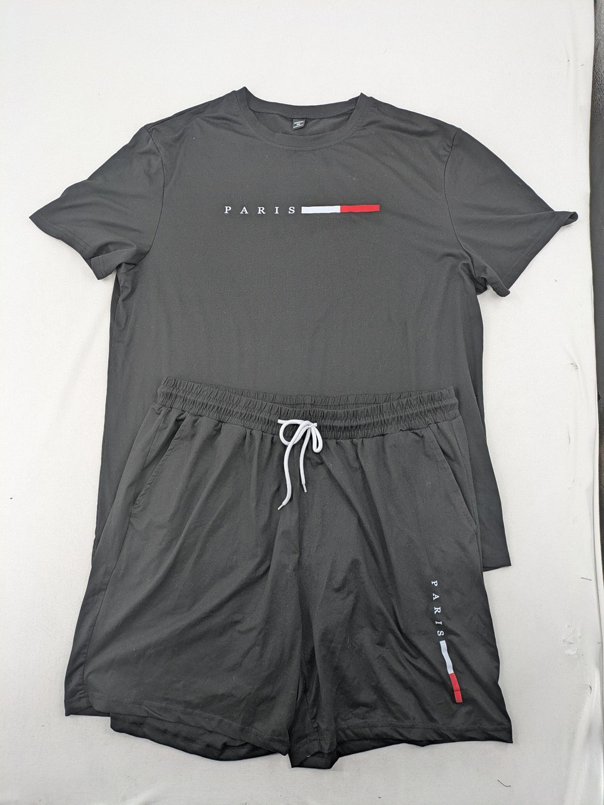 Manfinity loungewear set black T-shirt and shorts with Paris graphic print.