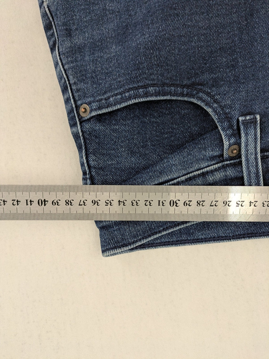 Levi's high waisted taper jeans dark blue 5-pocket design with zipper and stretch material.