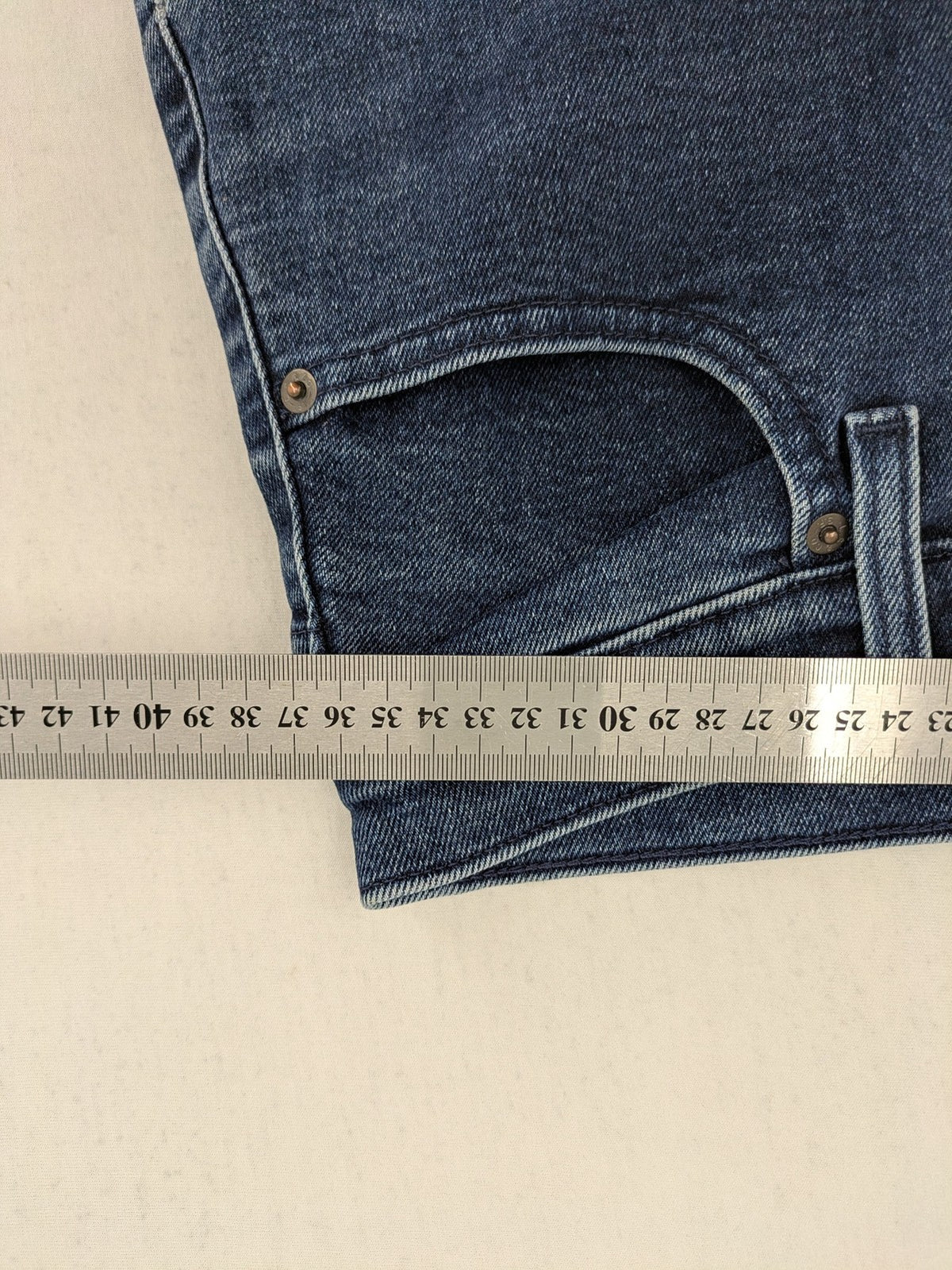 Levi's high waisted taper jeans dark blue 5-pocket design with zipper and stretch material.