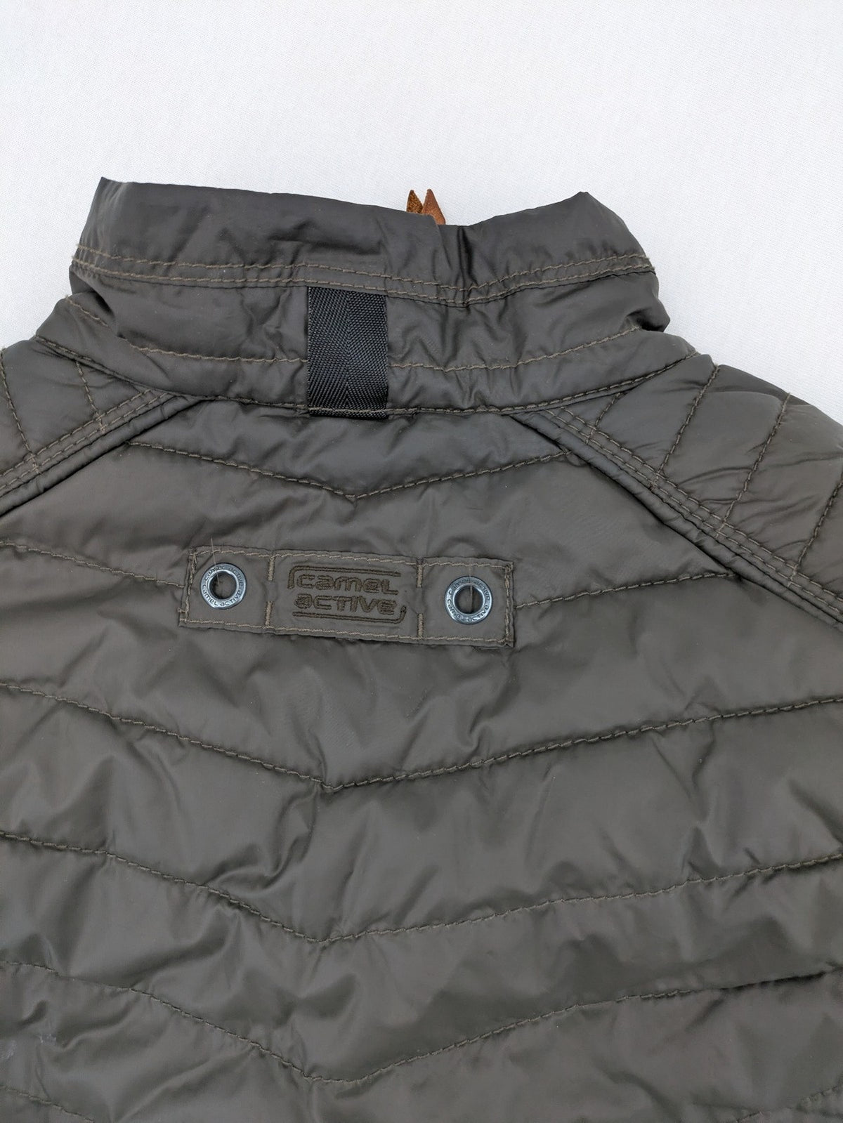 Camel Active khaki vest with full zip, quilted design, checkered lining, water-resistant.