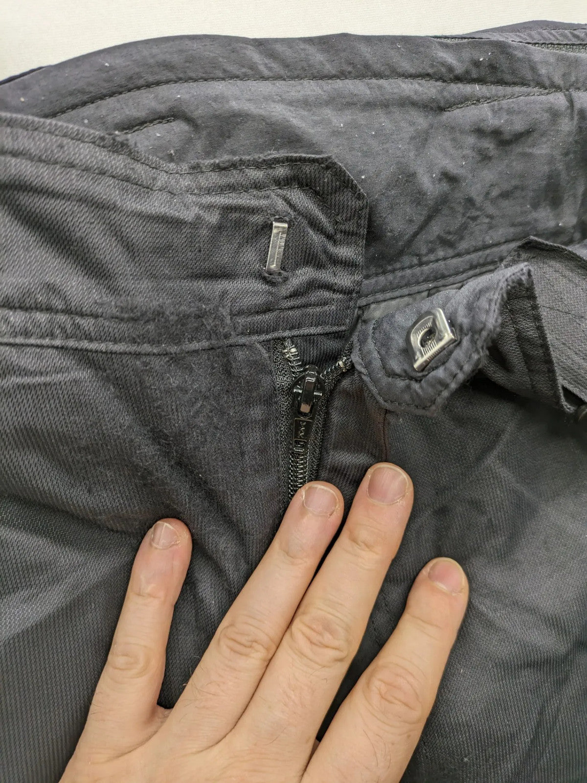 Schoffel black ski pants with adjustable straps, zip pockets, and snow gaiters.