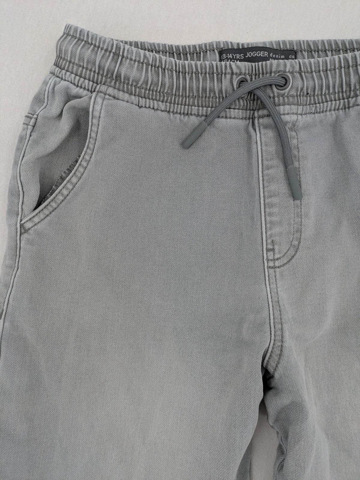 Denim & Co. grey jogger jeans with elastic waistband and ankle cuffs, cotton material.
