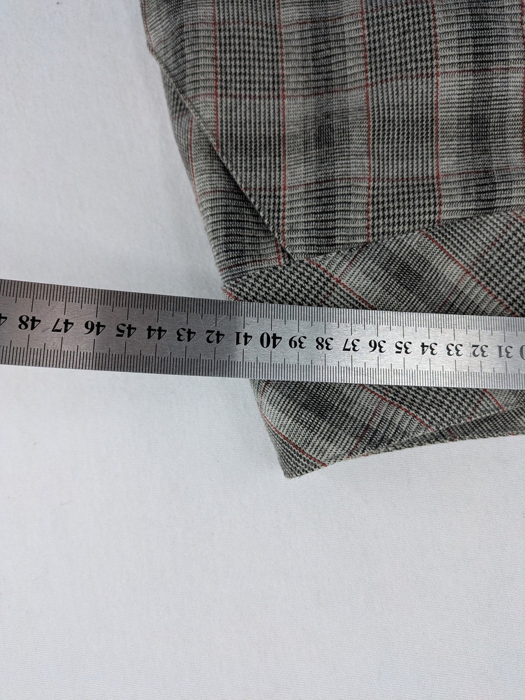 Lindex grey checkered bermuda shorts with red accents, high waist, decorative button detail.