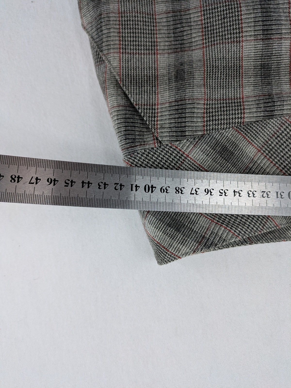 Lindex grey checkered bermuda shorts with red accents, high waist, decorative button detail.