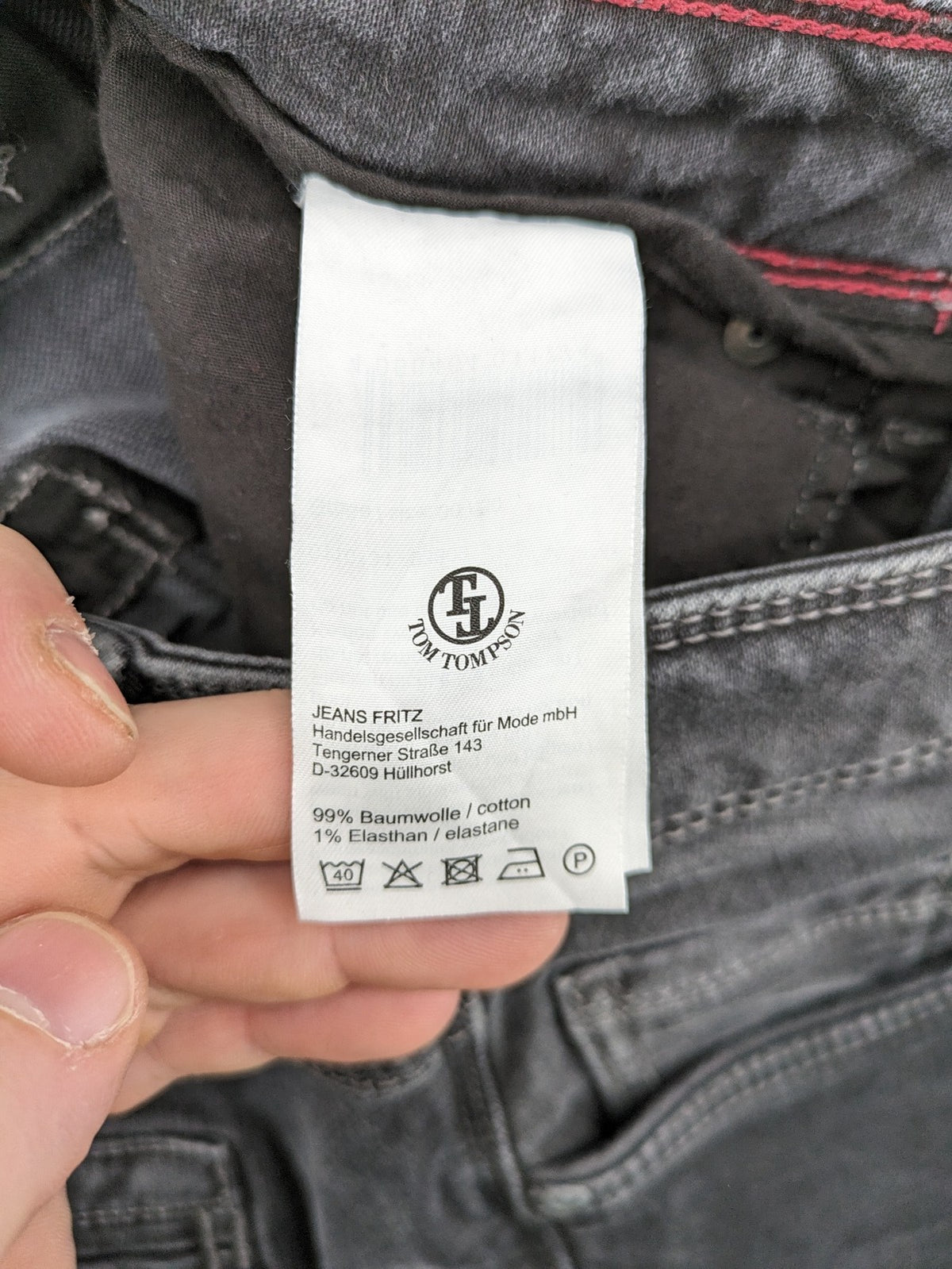 Tom Tompson grey slim tapered jeans with washed denim finish and subtle branding.