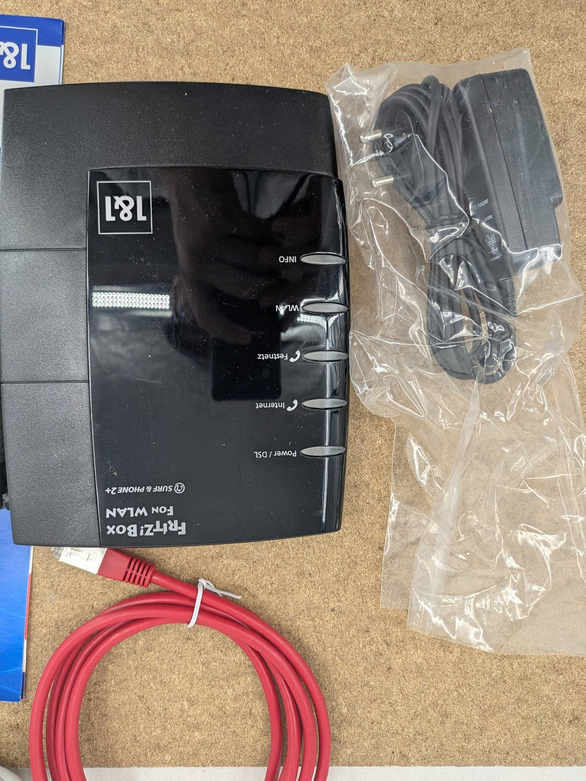 AVM VoIP gateway router blue with integrated DSL modem and phone system features.