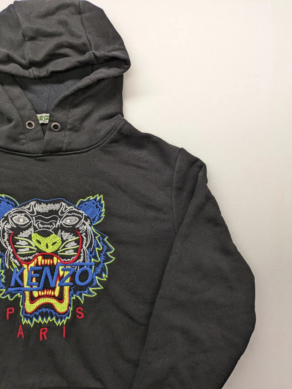 Kenzo multi hoodie with embroidered tiger graphic, drawstring hood, and kangaroo pocket.