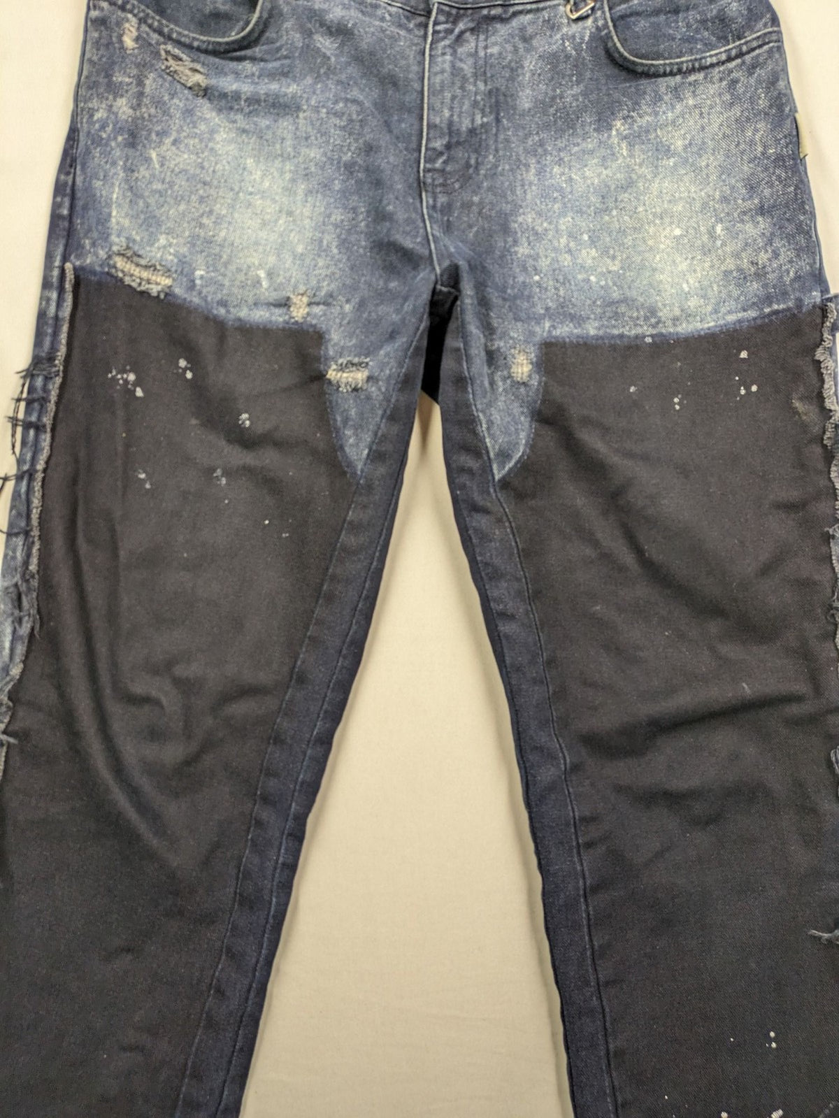 Reternity straight jeans blue black patchwork design with distressed details and frayed seams.