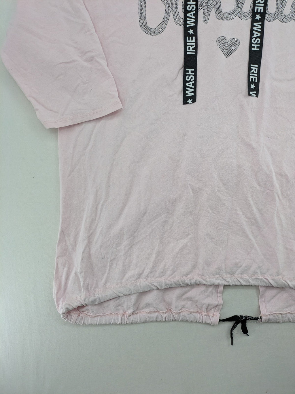 Irie pink turtle neck jumper with "Oohlala" rhinestone lettering and logo drawstrings.