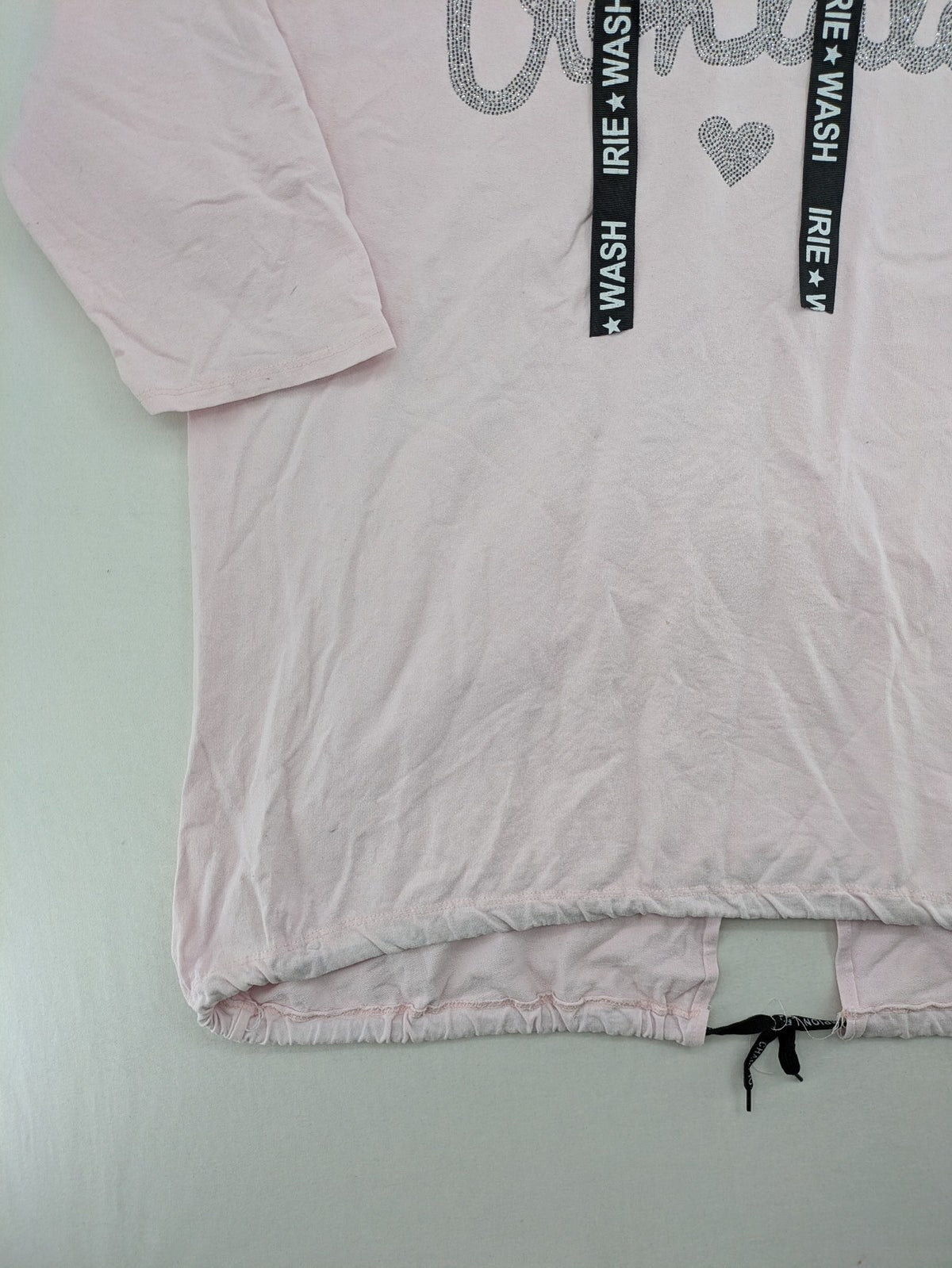 Irie pink turtle neck jumper with "Oohlala" rhinestone lettering and logo drawstrings.