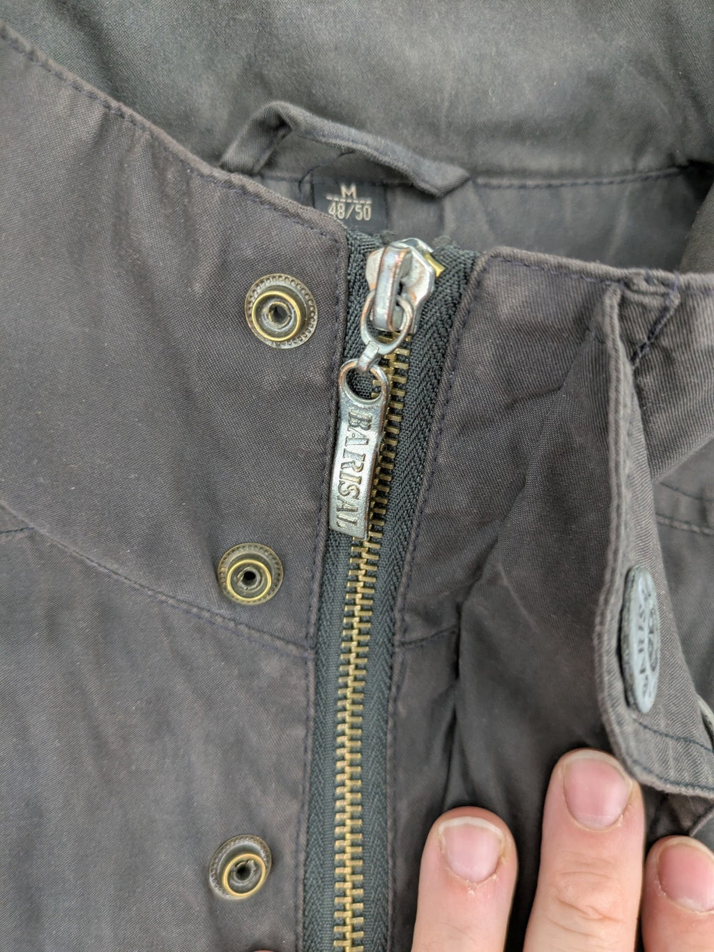 Barisal grey coat with hood, cargo pockets, and checkered lining detail.