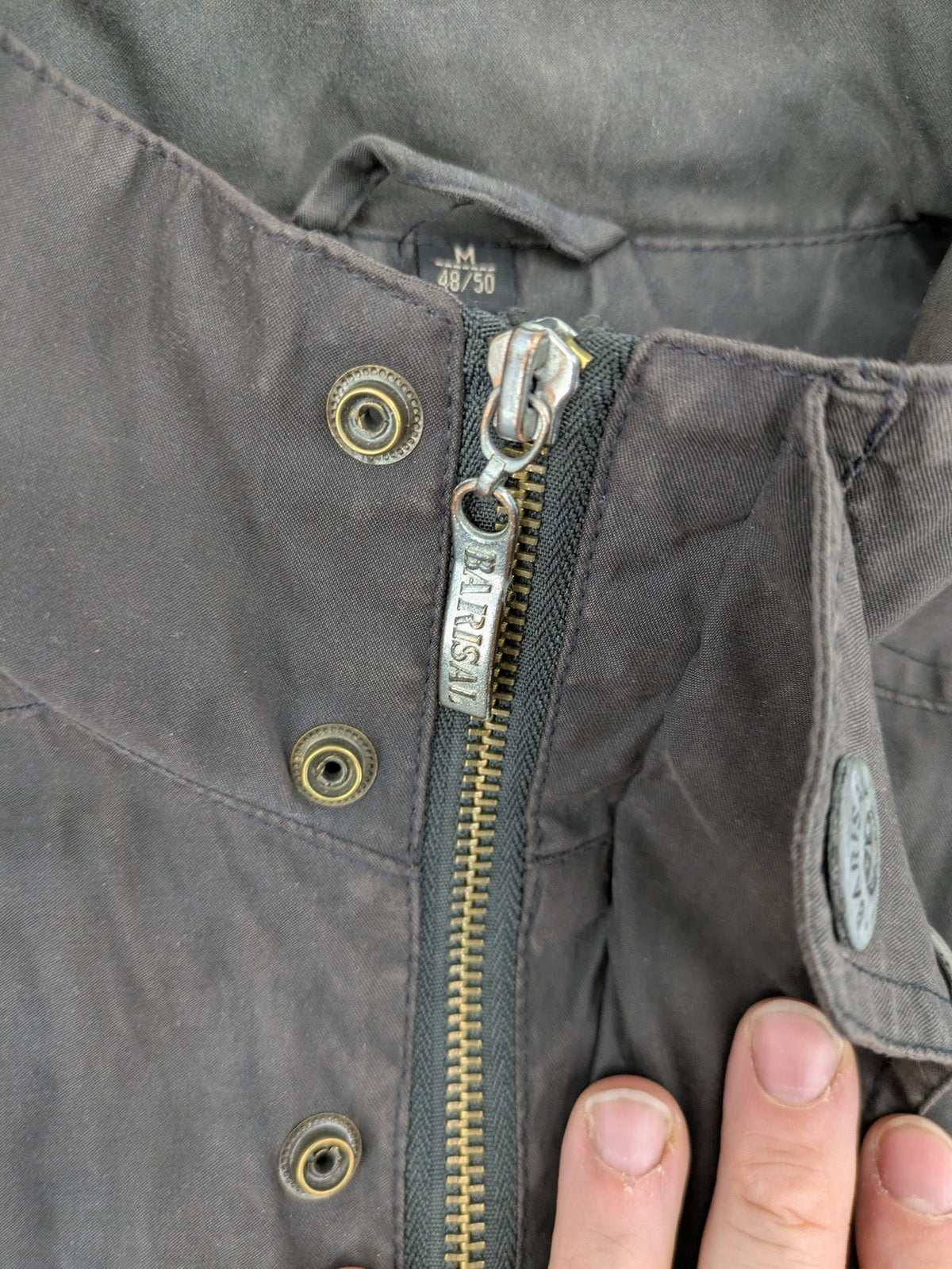 Barisal grey coat with hood, cargo pockets, and checkered lining detail.