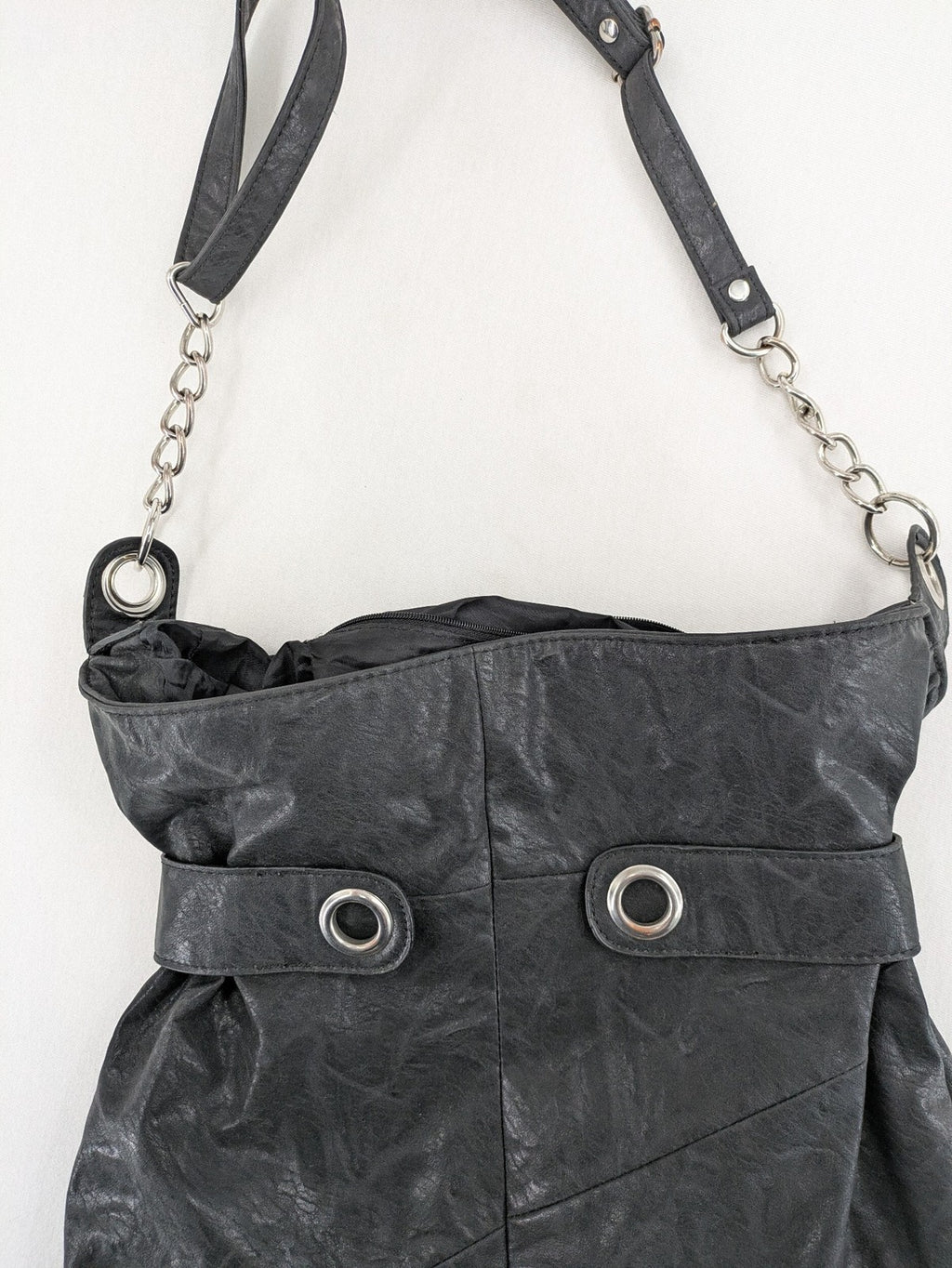New Yorker black hobo handbag with silver chain details and large eyelets.