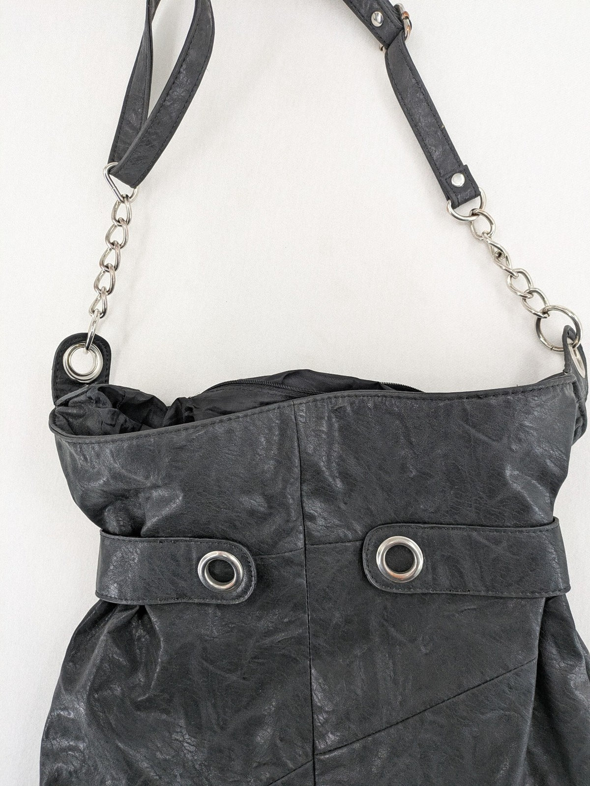 New Yorker black hobo handbag with silver chain details and large eyelets.