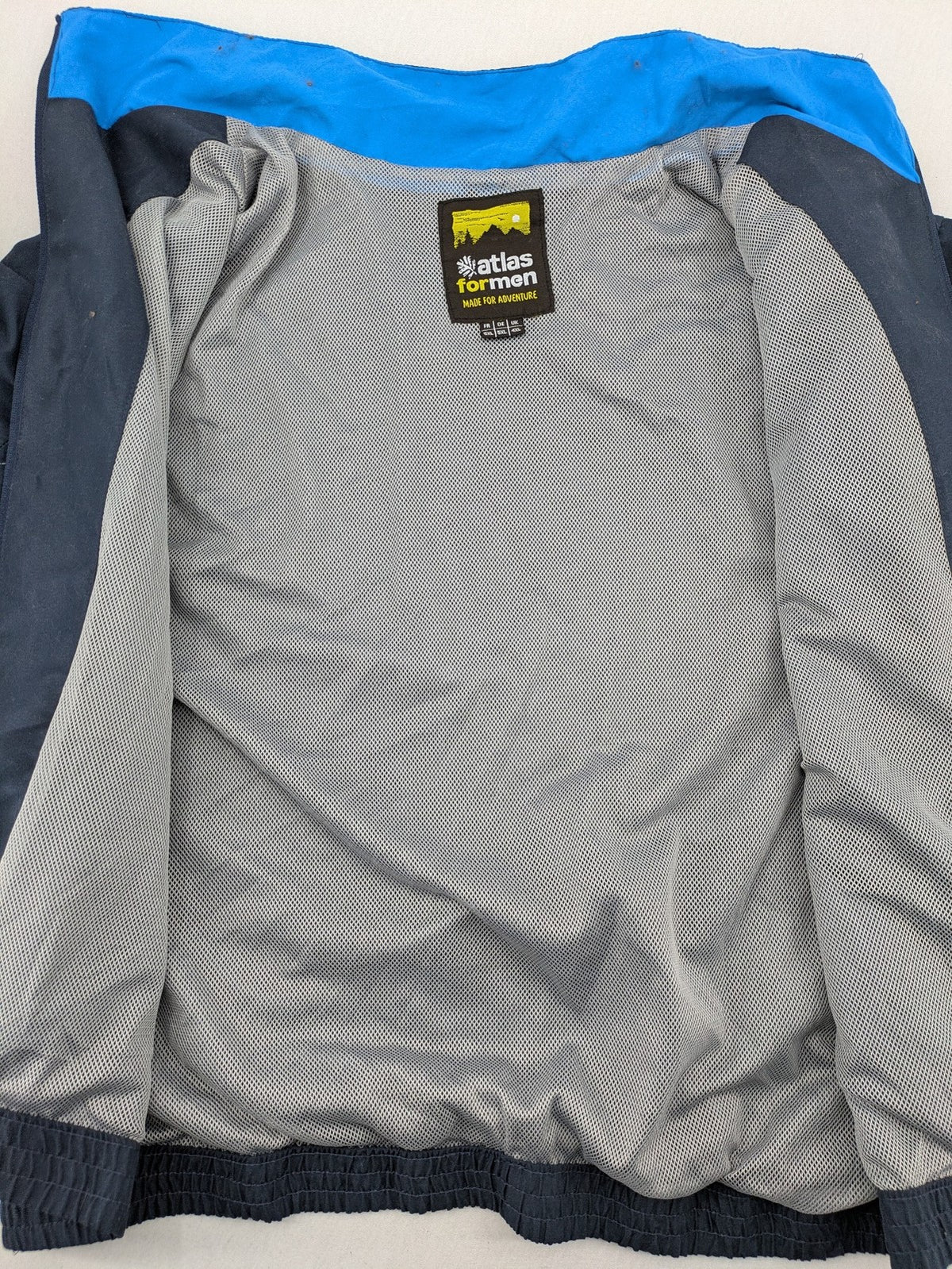 Atlas for Men blue windbreaker jacket with XTREM TECH SPORT graphic print and full zip.
