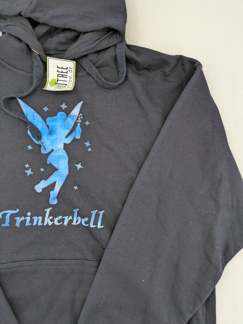 Trinkerbell black zip-through hoodie with blue graphic and adjustable drawstring hood.
