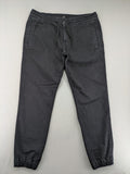 C&A grey jogger pants with elastic cuffs, drawstring waist, and multiple pockets.
