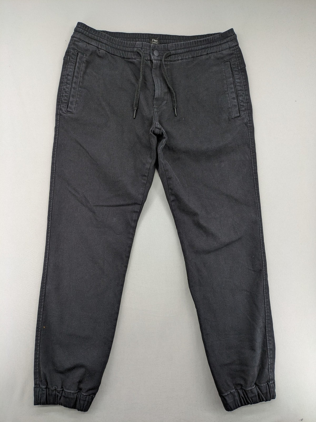 C&A grey jogger pants with elastic cuffs, drawstring waist, and multiple pockets.